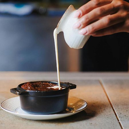 Stock Exchange Hotel, Manchester, Autograph Collection Экстерьер фото A pot of chocolate pudding being topped with cream